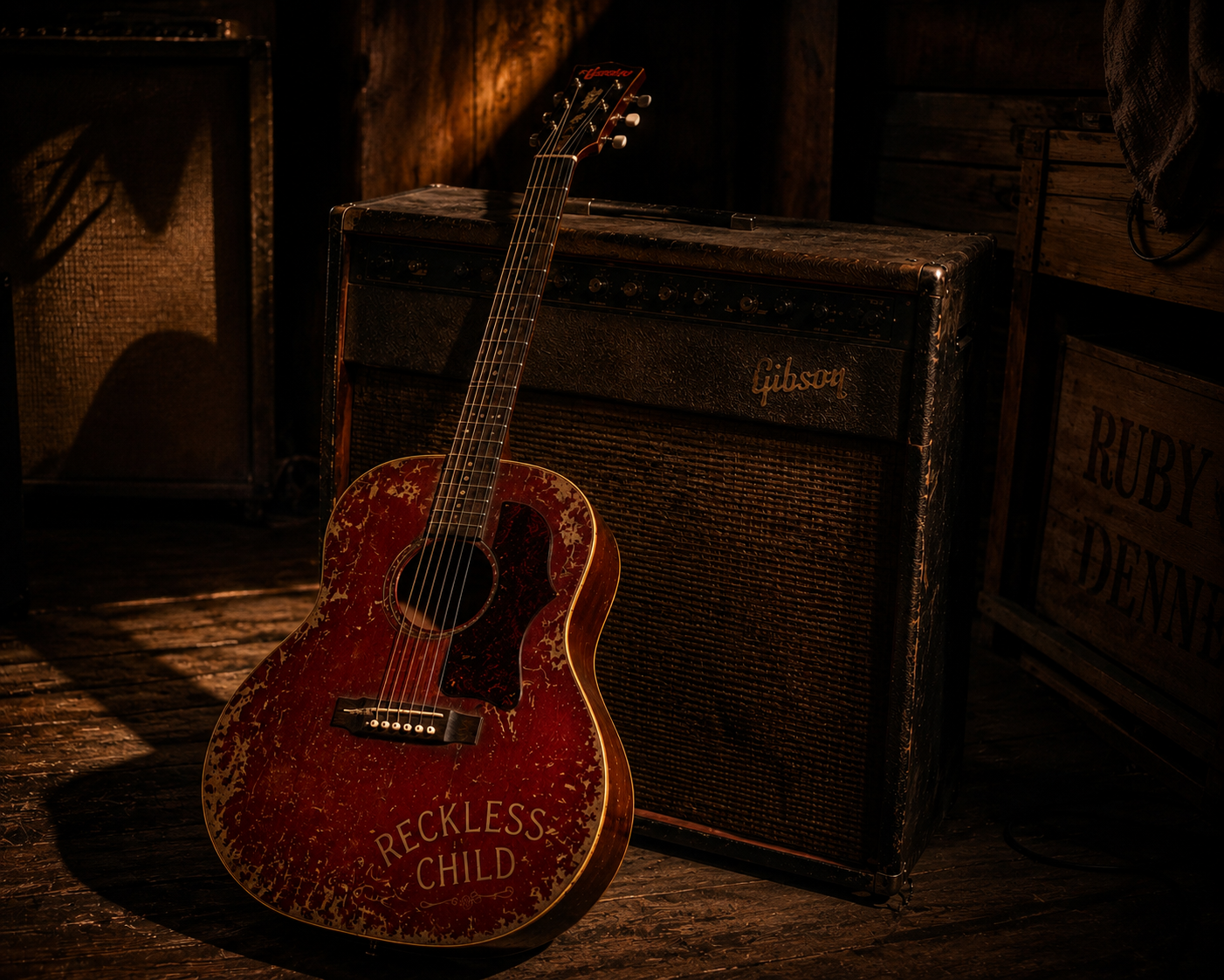 Reckless Child, Ruby Devine's old red acoustic guitar, resting against a vintage Gibson amplifier.